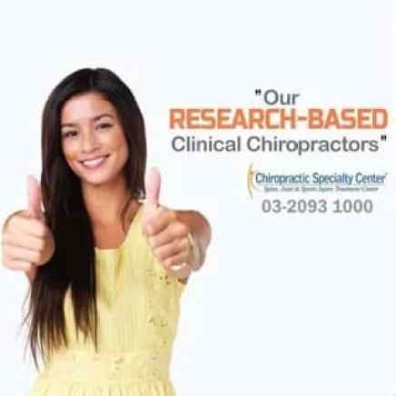 Female giving chiropractic care two thumbs up