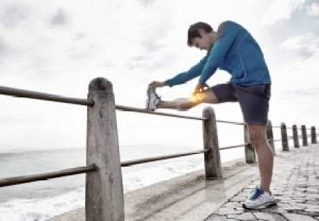 man stretching a painful knee