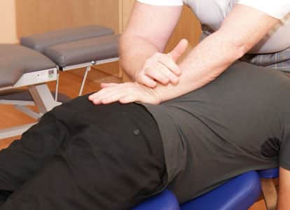 Felxion-distraction therapy by chiropractor shown